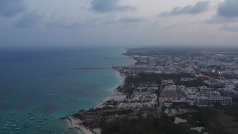 Shoreline-and-Caribbean-Sea-at-Playa-del-Carmen,-Mexico.-Amazing-cityscape-and-seascape-during-sunset.-Aerial-view