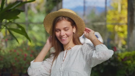 woman in a straw hat in a greenhouse