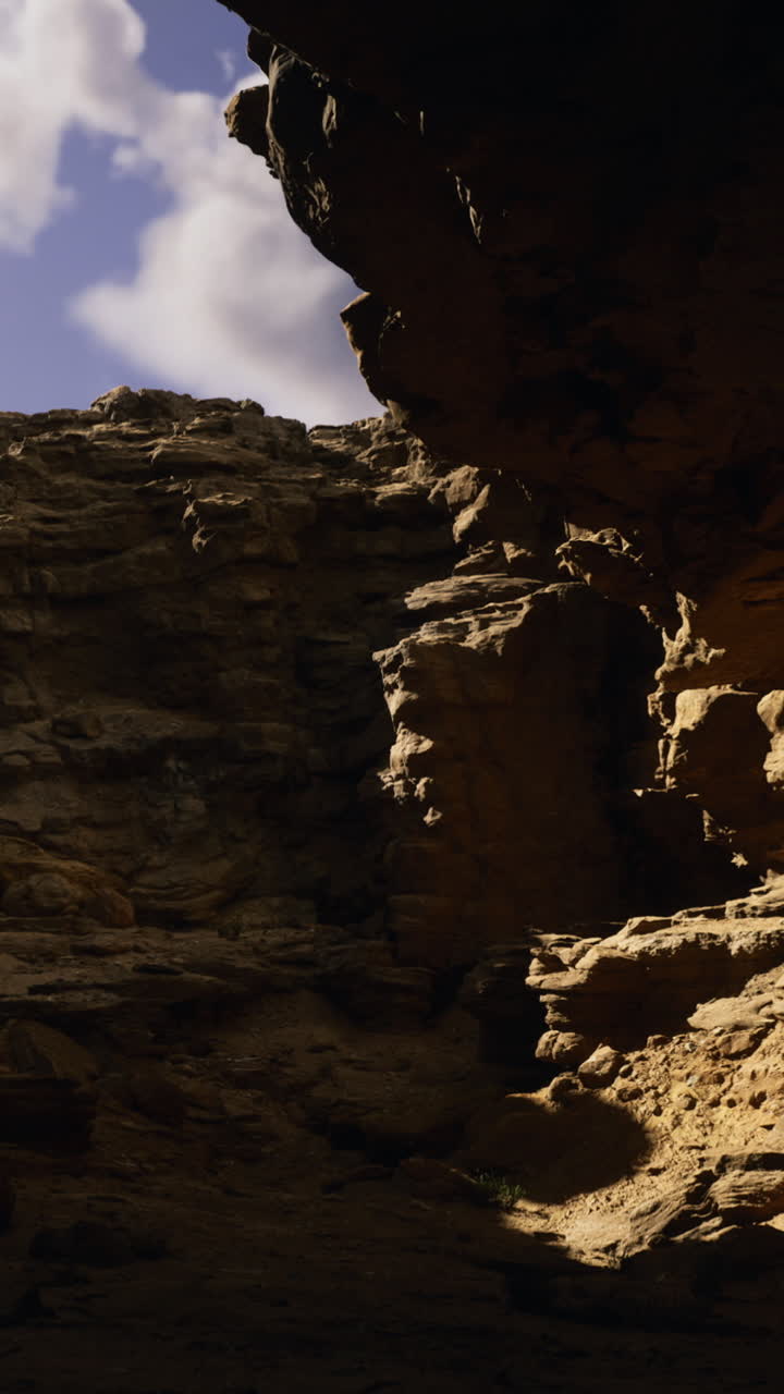 Natural rock formations create dramatic light in a canyon at midday