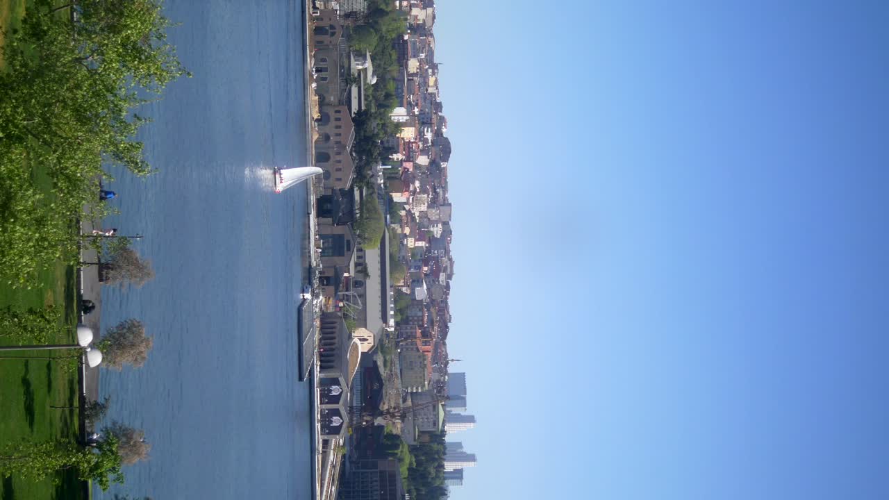 Cityscape with River and Sailboat