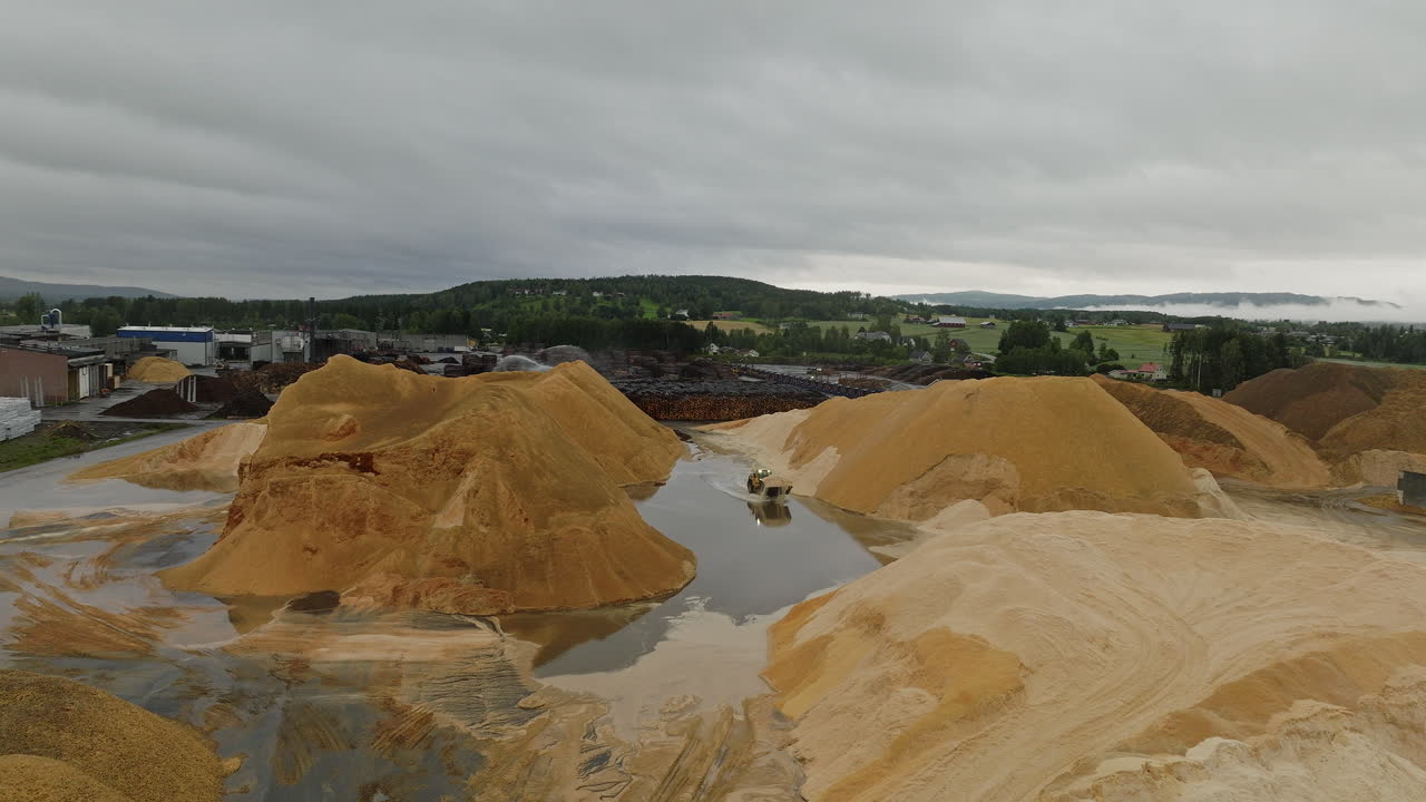Sawdust mountains at lumber yard in Braskereidfoss, Norway