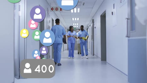 animation of media icons over diverse doctors walking and talking in hospital