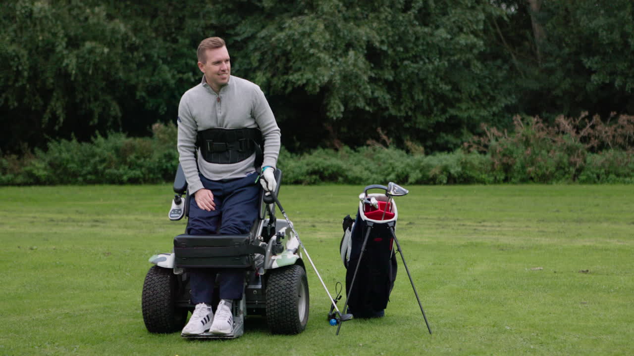 Man playing golf with adaptive equipment