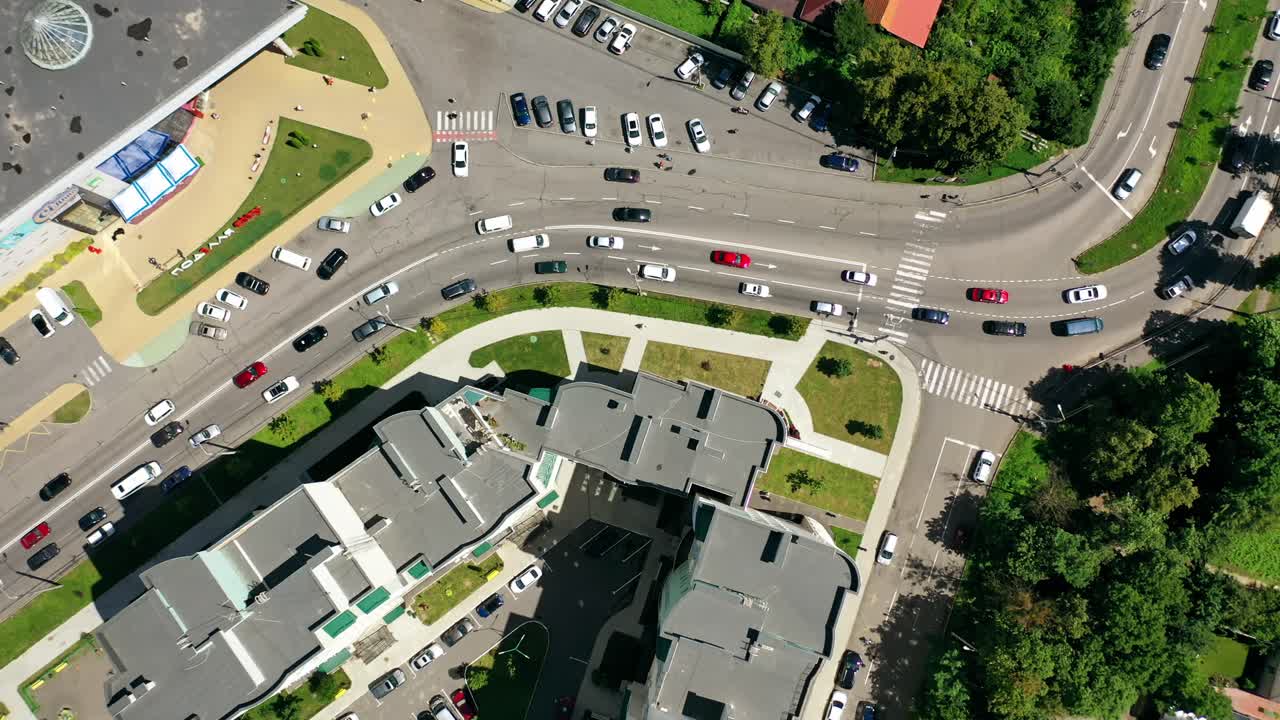 Traffic in the city. Cars moving and standing on parking zone in modern city. Car traffic and parking concept. City filled with cars. City ecology. Aerial view.