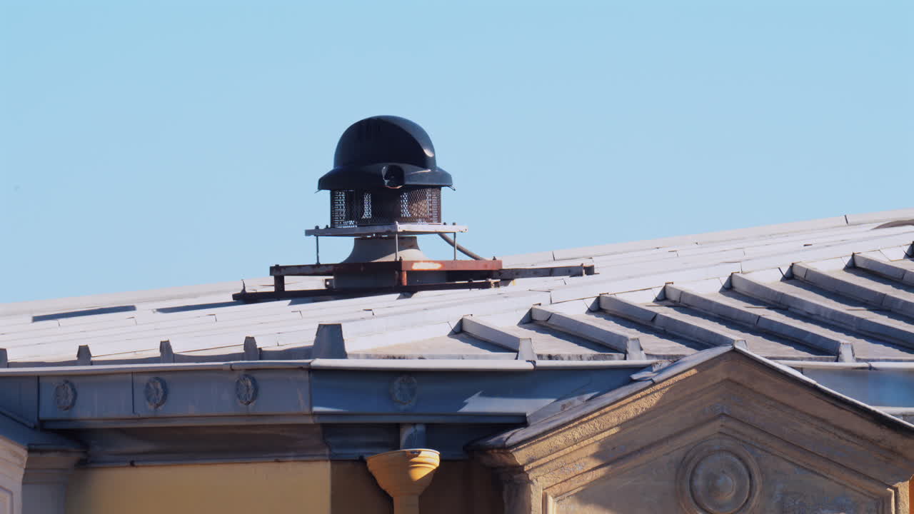 Close up of the facade and rooftop of a yellow building in Nice, France