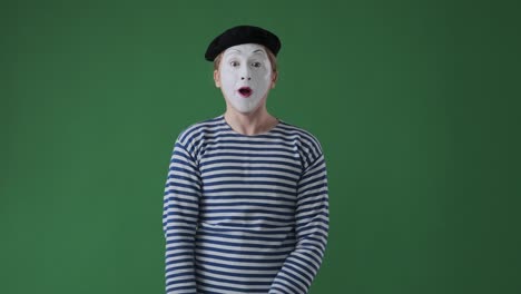 mime man waving hand over green background