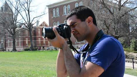 Man-takes-photos-with-DSLR-camera