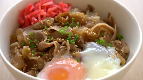 rice topped with slice pork and onsen egg - japanese food