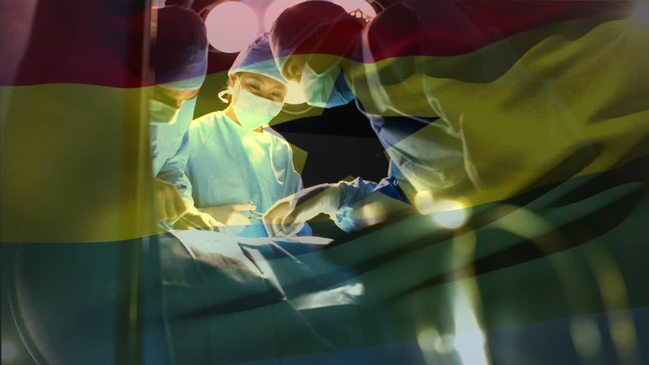 Animation of flag of ghana waving over surgeons in operating theatre