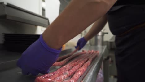 butcher making long delicious and fresh sausages, close up