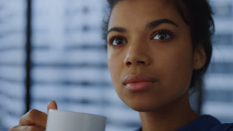 dreamy woman drinking coffee in office. thoughtful business woman face