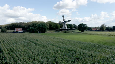 low aerial towards traditional windmill in a beautiful rural area