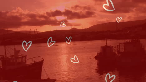 heart shapes animation over boats on calm water at sunset