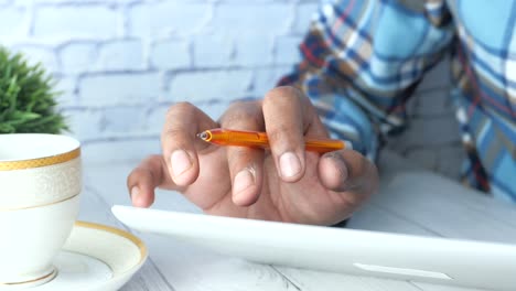 person using a tablet with a pen