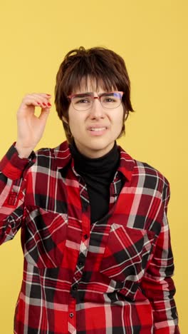 woman with a confused or disgusted expression adjusting her glasses