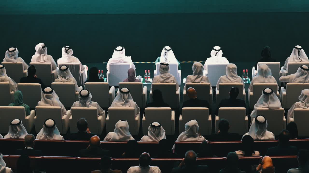 Large Group of People in Traditional Clothing at a Conference