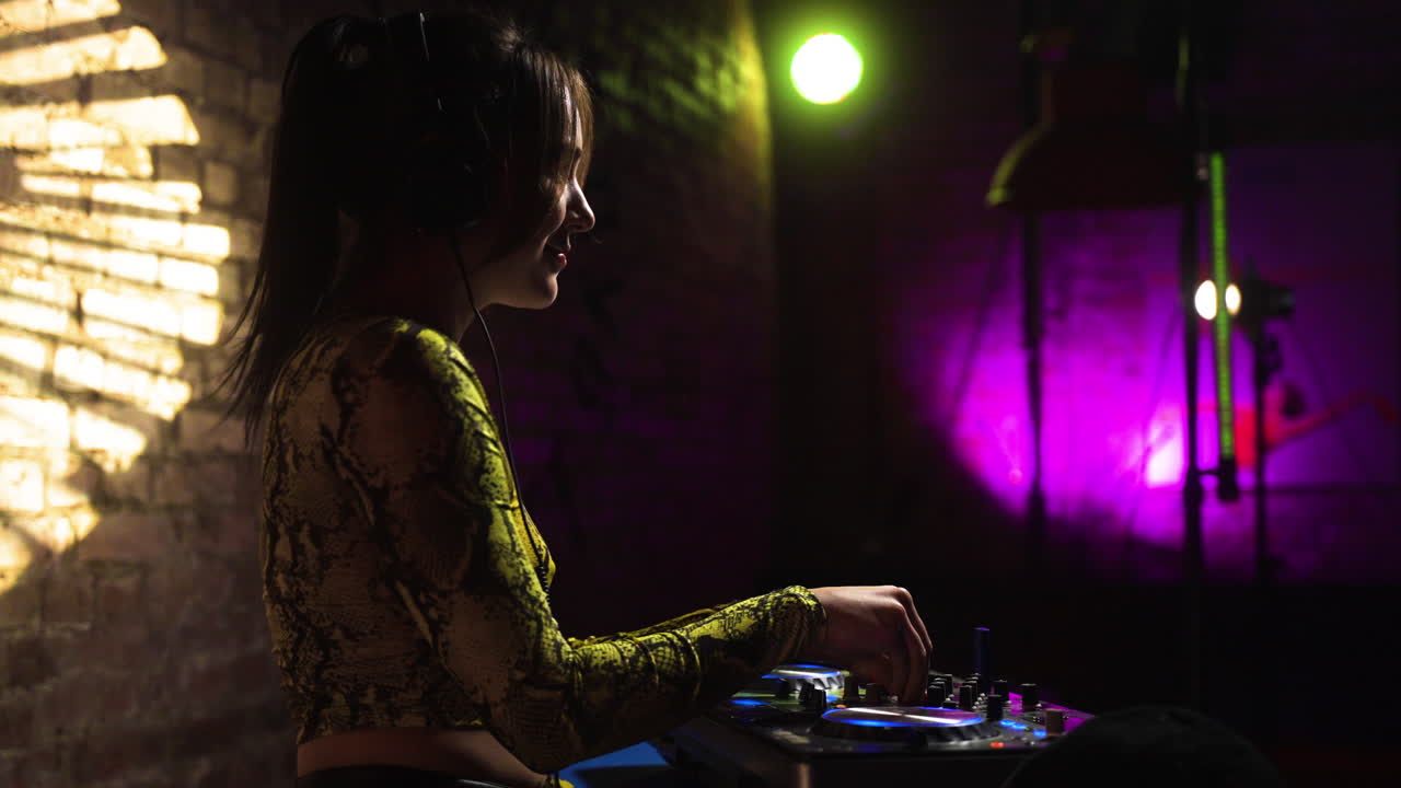 Woman with headphones djing at the disco