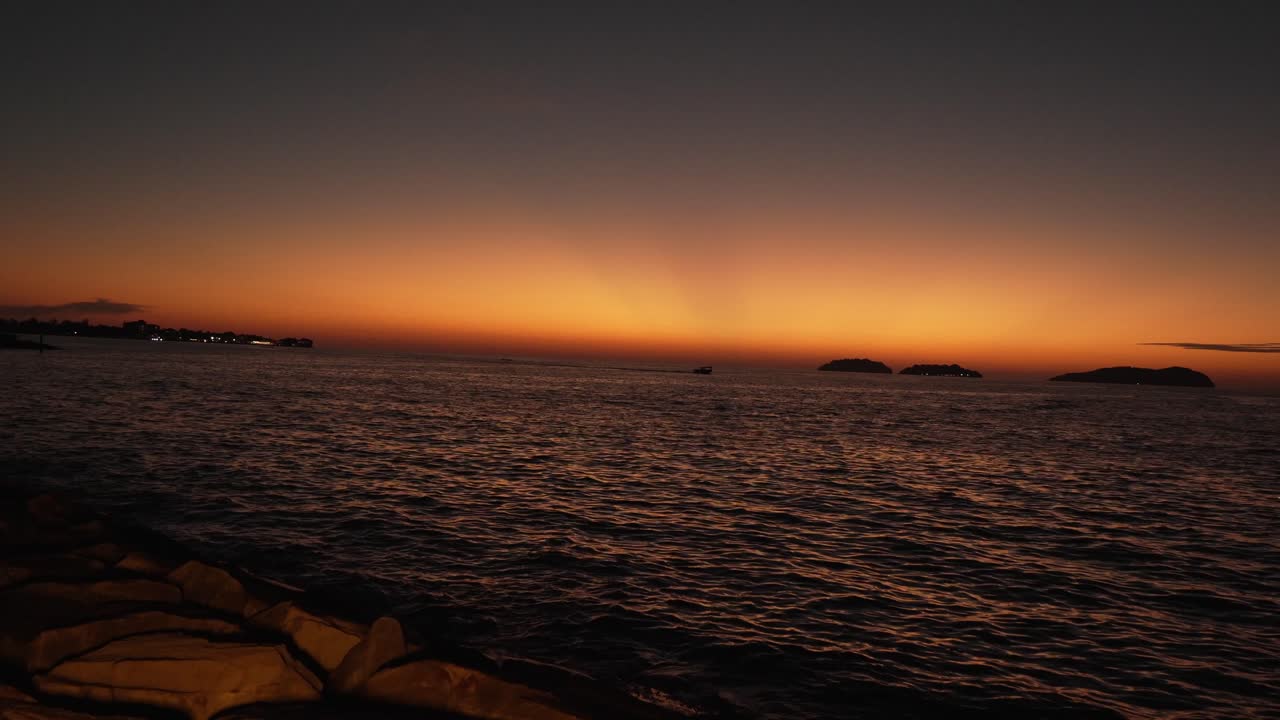 Beautiful stuning sunset,with nice city background,with boat and blue sea