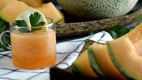 whole and sliced of japanese melons,honey melon or cantaloupe (cucumis melo) glass of melon smoothie healthcare concept.