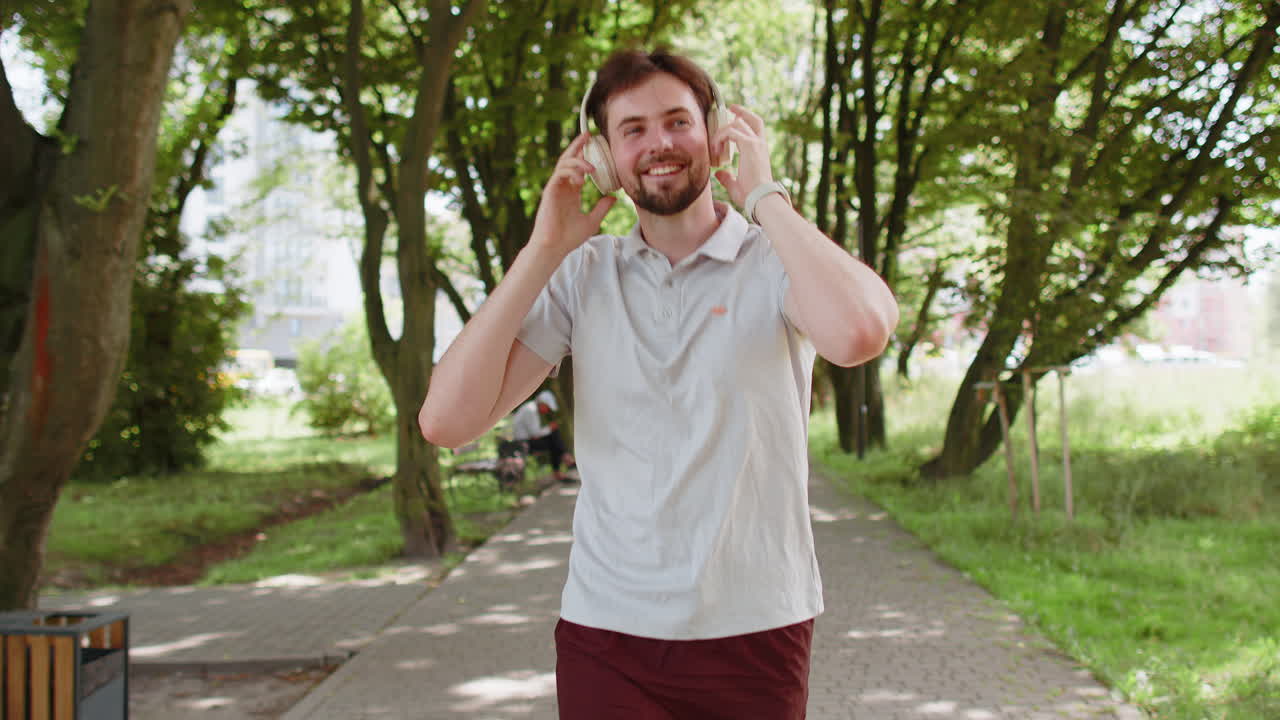 Athletic fitness sport jogger man training marathon run listening music in headphones morning park