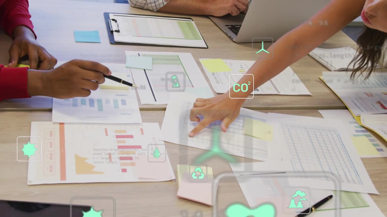 Left lead at table pointing pen right lead moving sheets causing AR icons showing environment data
