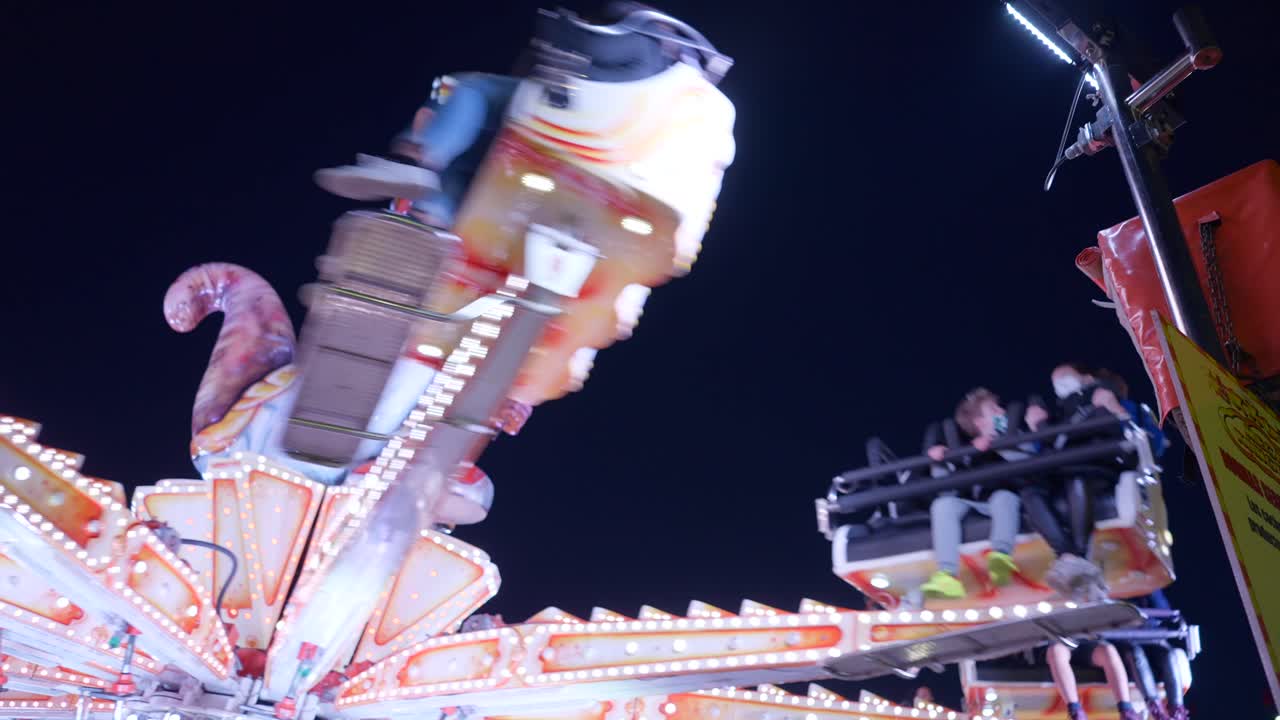 Spinning Rides at Nighttime Carnival