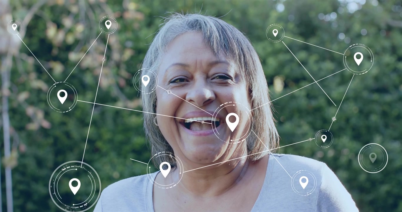Senior woman receiving white pin near chest and expanding technology network laughing
