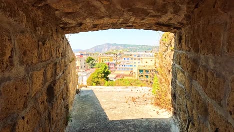 view through ancient stone window in naples, italy