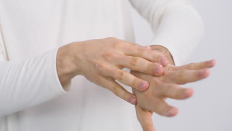 Young-Man-Applying-Hand-Cream