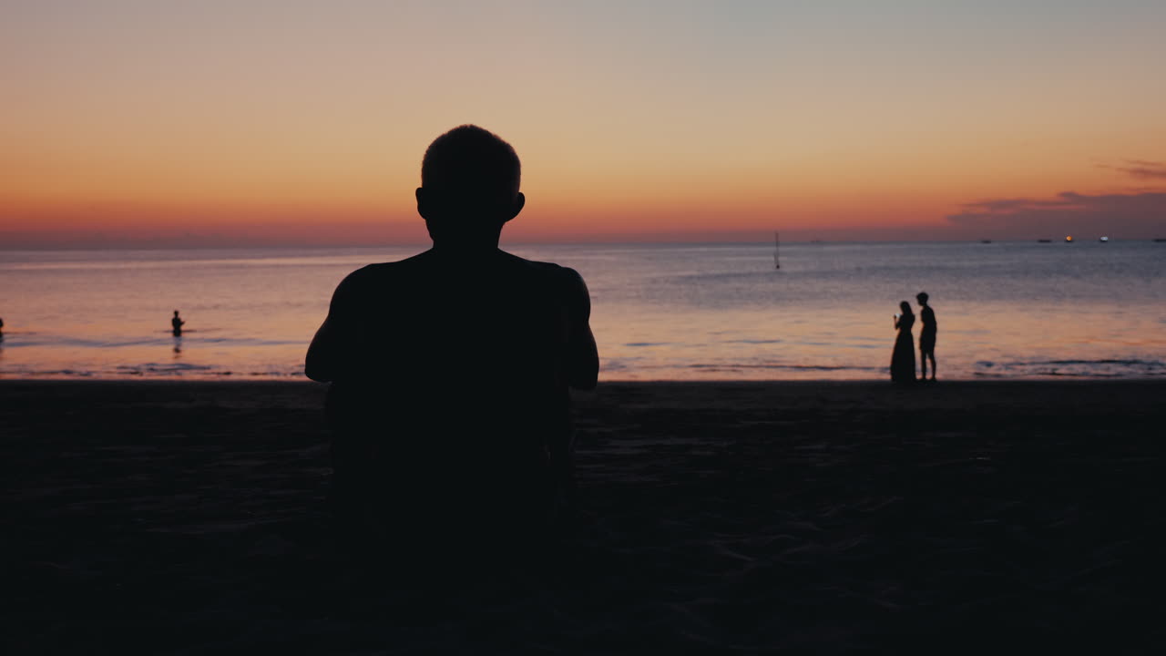 Man watching sunset on the beach