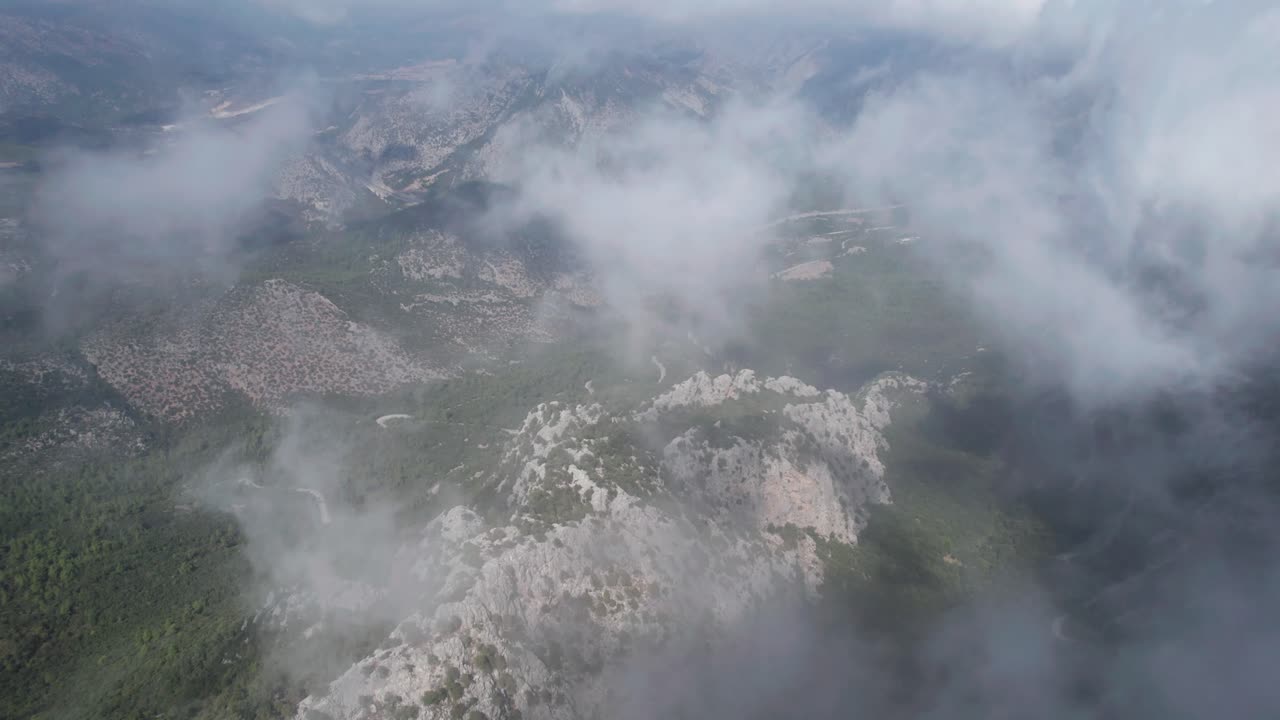 drone aéreo sobre nubes y montañas en el valle de termessos, turquía, inclinación hacia adelante hacia abajo