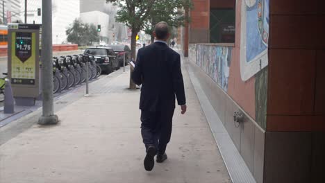 businessman walking on pavement