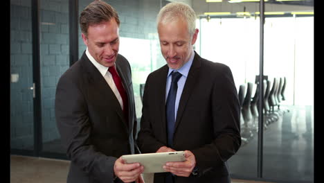 businessmen looking at tablet