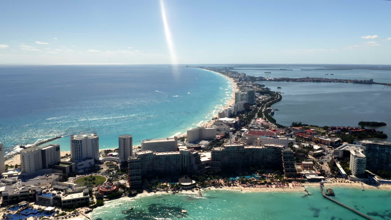 Blue sea bay and coastal Cancun city skyline in sunlight, Mexico