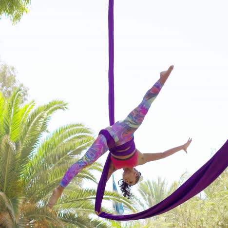 fit shapely female gymnast working out on ribbons