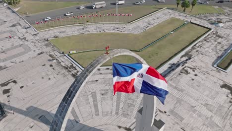 high angle of flag waving in the wind, plaza de la bandera at santo domingo city, dominican republic