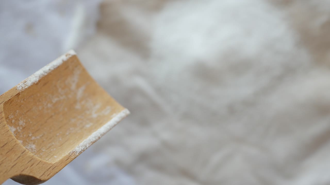 Wooden spoon with flour