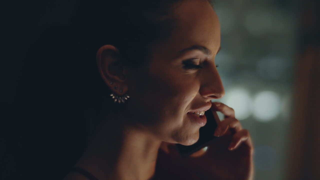 Joyful lady calling phone in panoramic night luxury flat closeup. Woman laughing