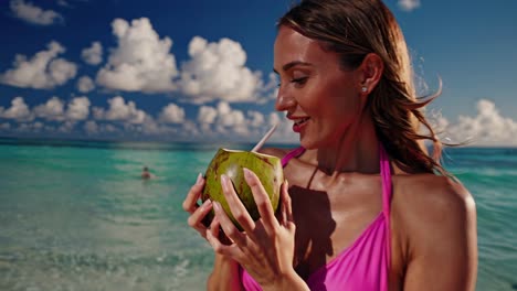 woman enjoying a coconut on a tropical beach