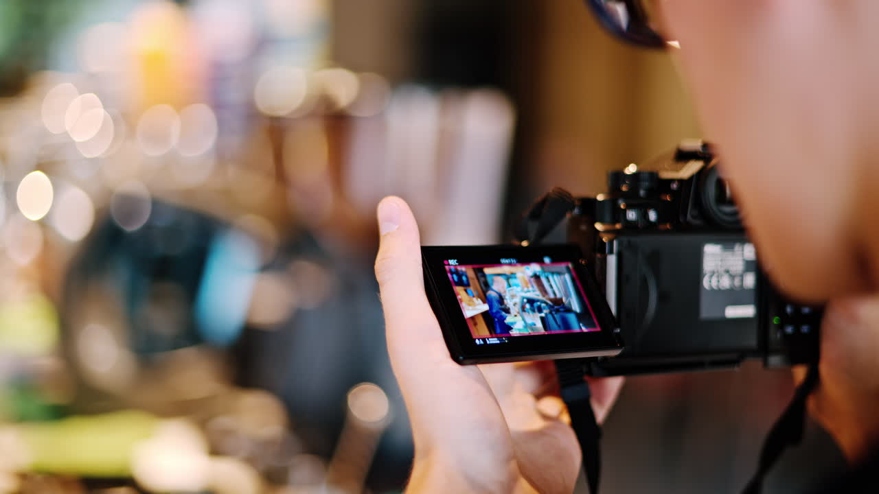 Man watching a video on a professional camera
