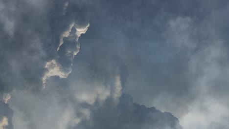 a thunderstorm in a dark cumulonimbus cloud , point of view