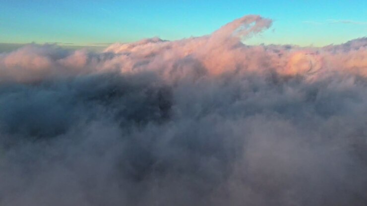 Beautiful sunset clouds above mountains, peaceful mood, calming colors
