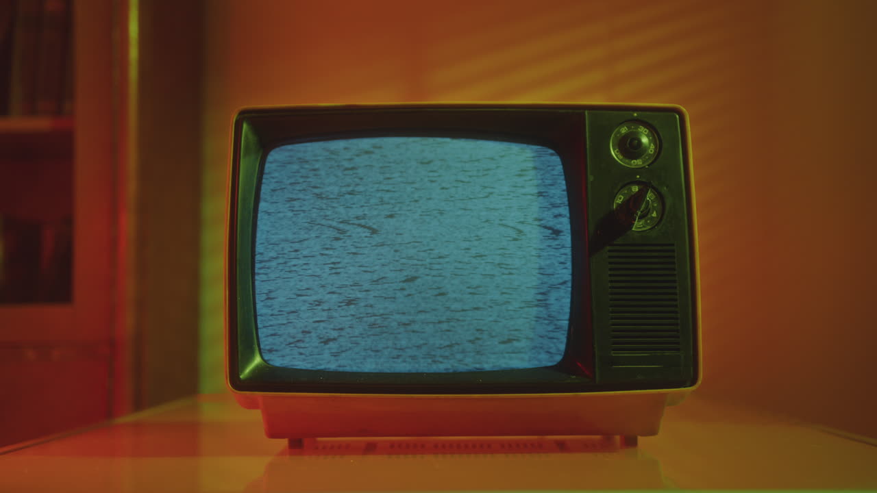 Retro Analog TV with Noise on Screen in Studio with Warm Light