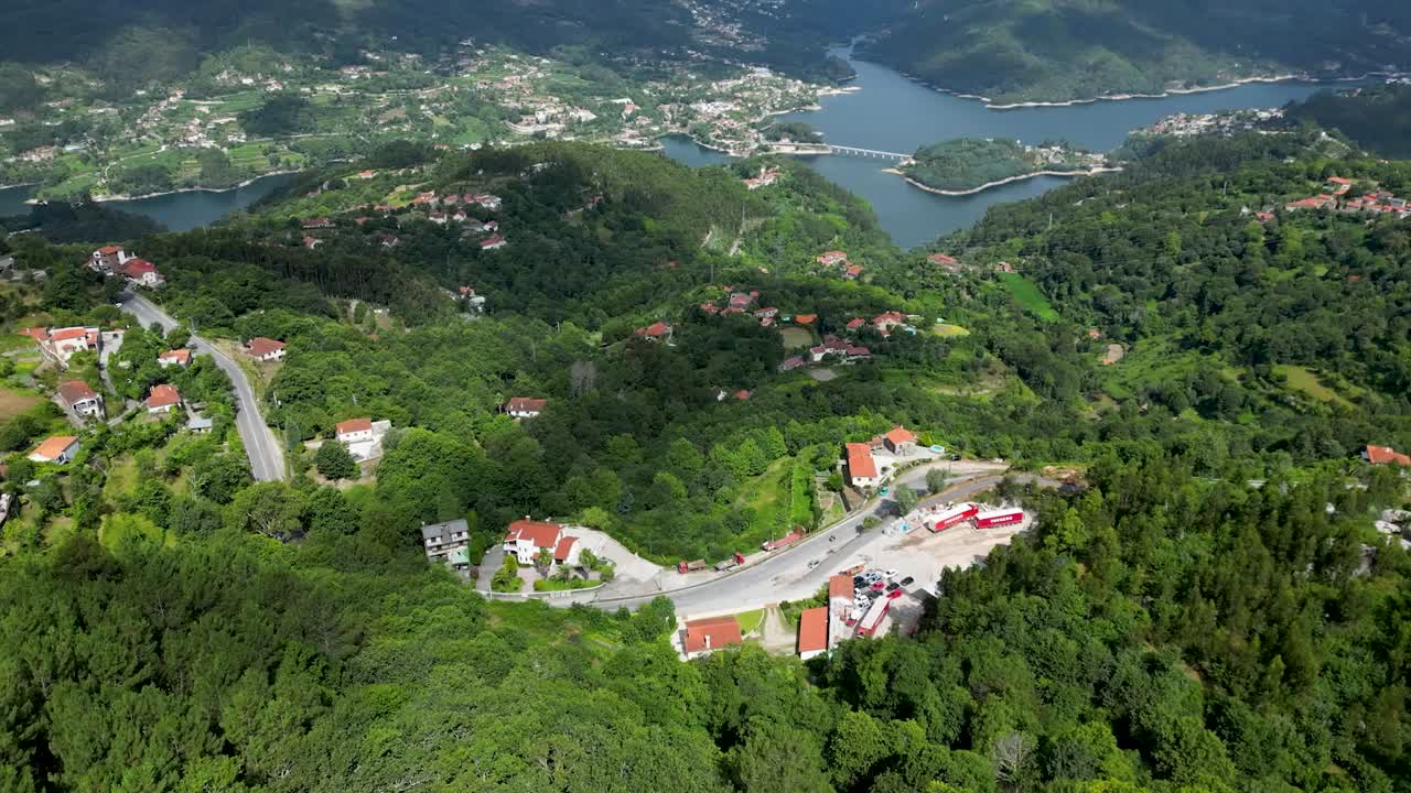 Aerial Perspective of Hillside Residences in Gerês National Park, Portugal, with Caniçada Dam Against a Sunny Sky, Parque Nacional Peneda-Gerês