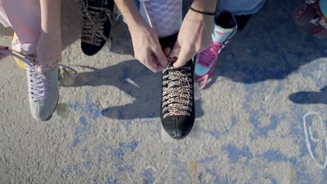 friends tying roller skates