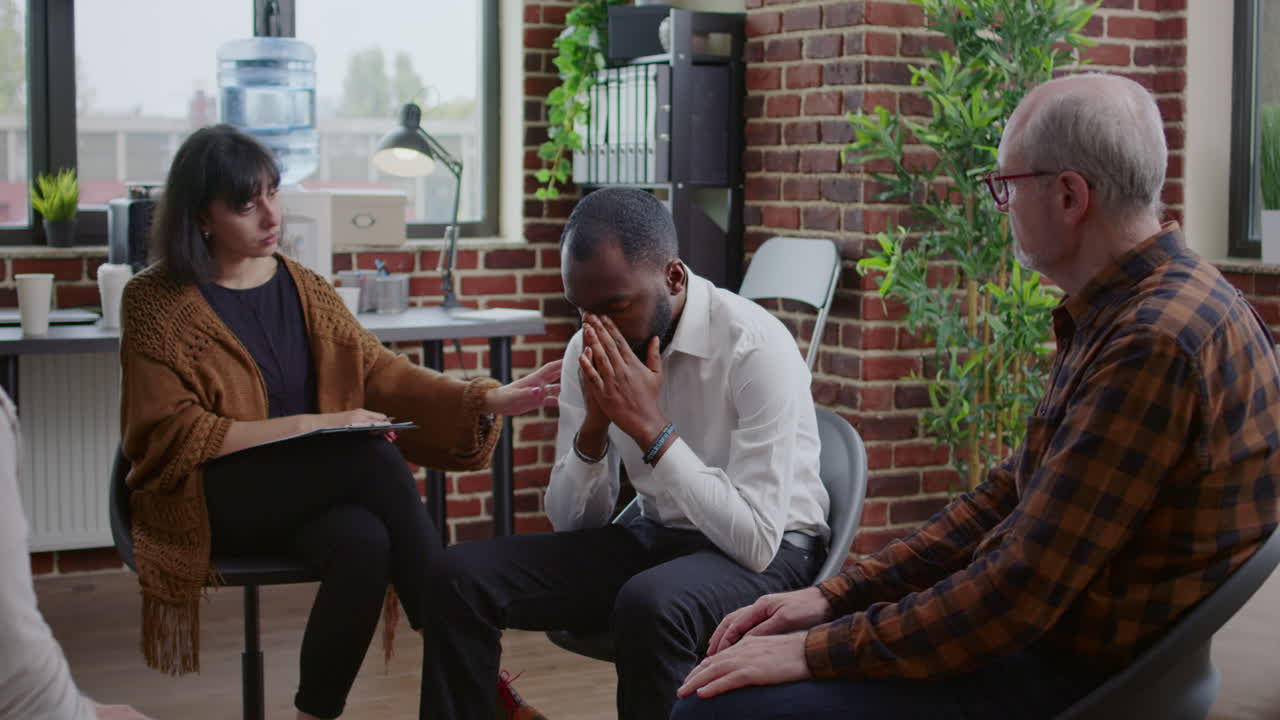 African american man sharing addiction story with group at aa therapy session