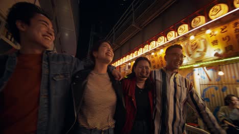 happy friends enjoying the night in japan