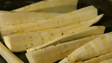 Chopped-Parsnips-Seasoned-with-Pepper-and-Rosemary-Ready-to-be-Roasted