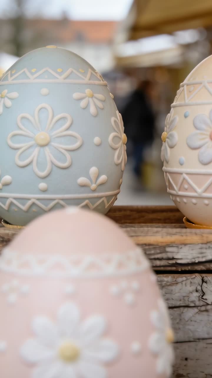 Vertical video: Camera shifting focus toward pastel blue floral egg on shelf, showing craft display