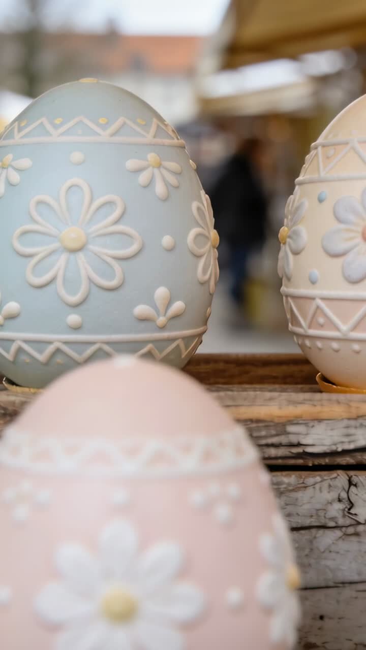 Vertical video: Camera shifting focus toward pastel blue floral egg on shelf, showing craft display